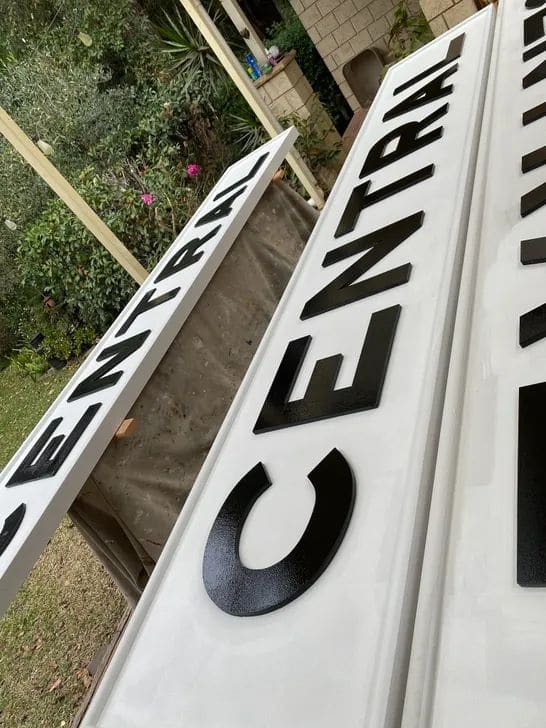Original metal raised letters and timber backboard during Central Station sign restoration